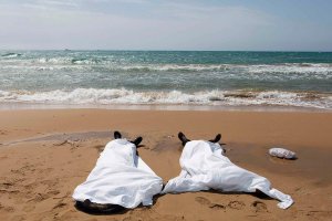 Bodies of migrants who drowned lie on the beach in the Sicilian village of Sampieri